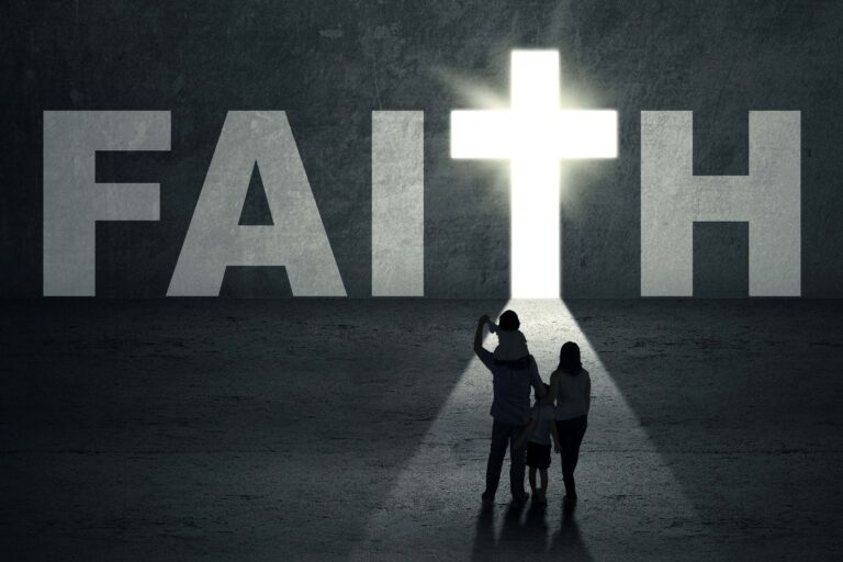 Faith Image with 2 people looking at the cross in the word Faith against dark grey image